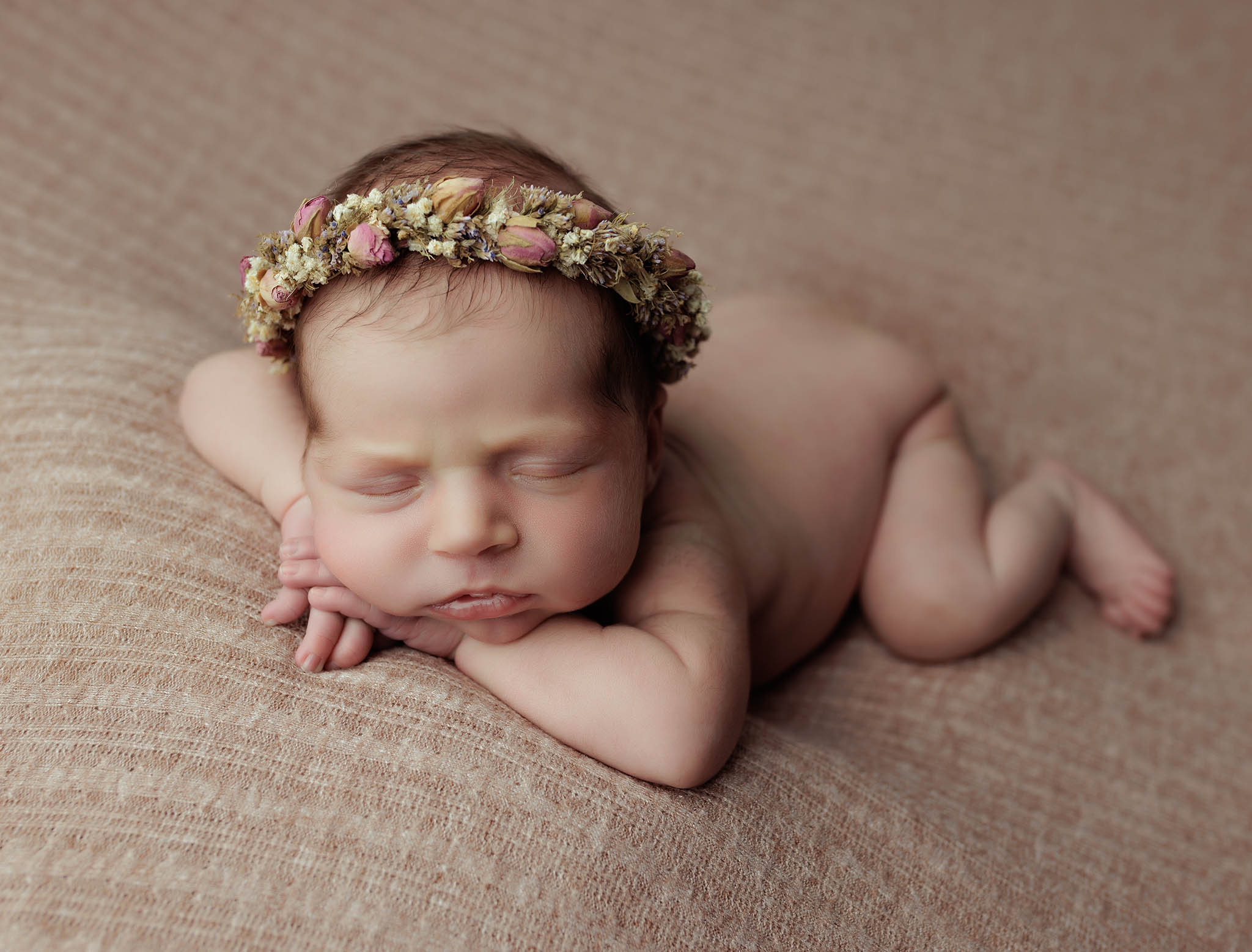 Baby boy on green with eyes open by Newborn Photographer Milton Keynes