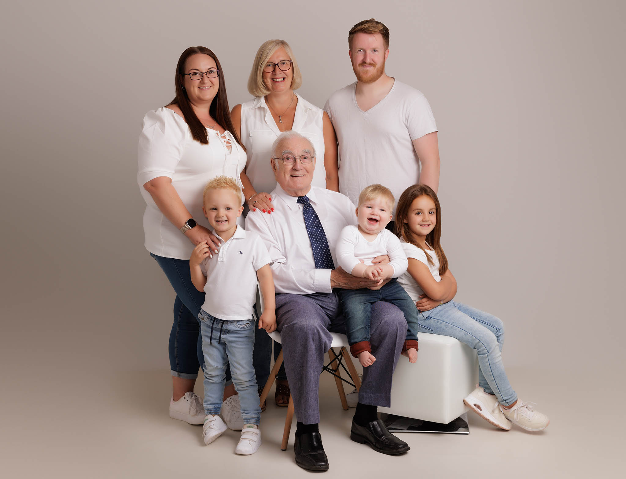 Family and newborn photographer in Milton Keynes photographs a family of five children wearing white tops
