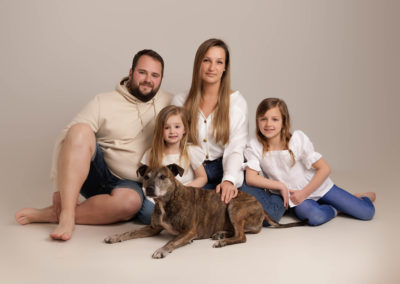 family with parents and two daughters and their dog, by newborn Photographer in Milton Keynes